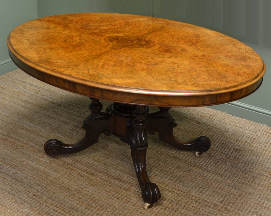 DS Victorian figured walnut loo table, oval bookmatch veneer top with banded  frieze, baluster pedestal with lobe carving, cabriole tripod base carved  and moulded with flower head and C-scro - Furniture, Rugs