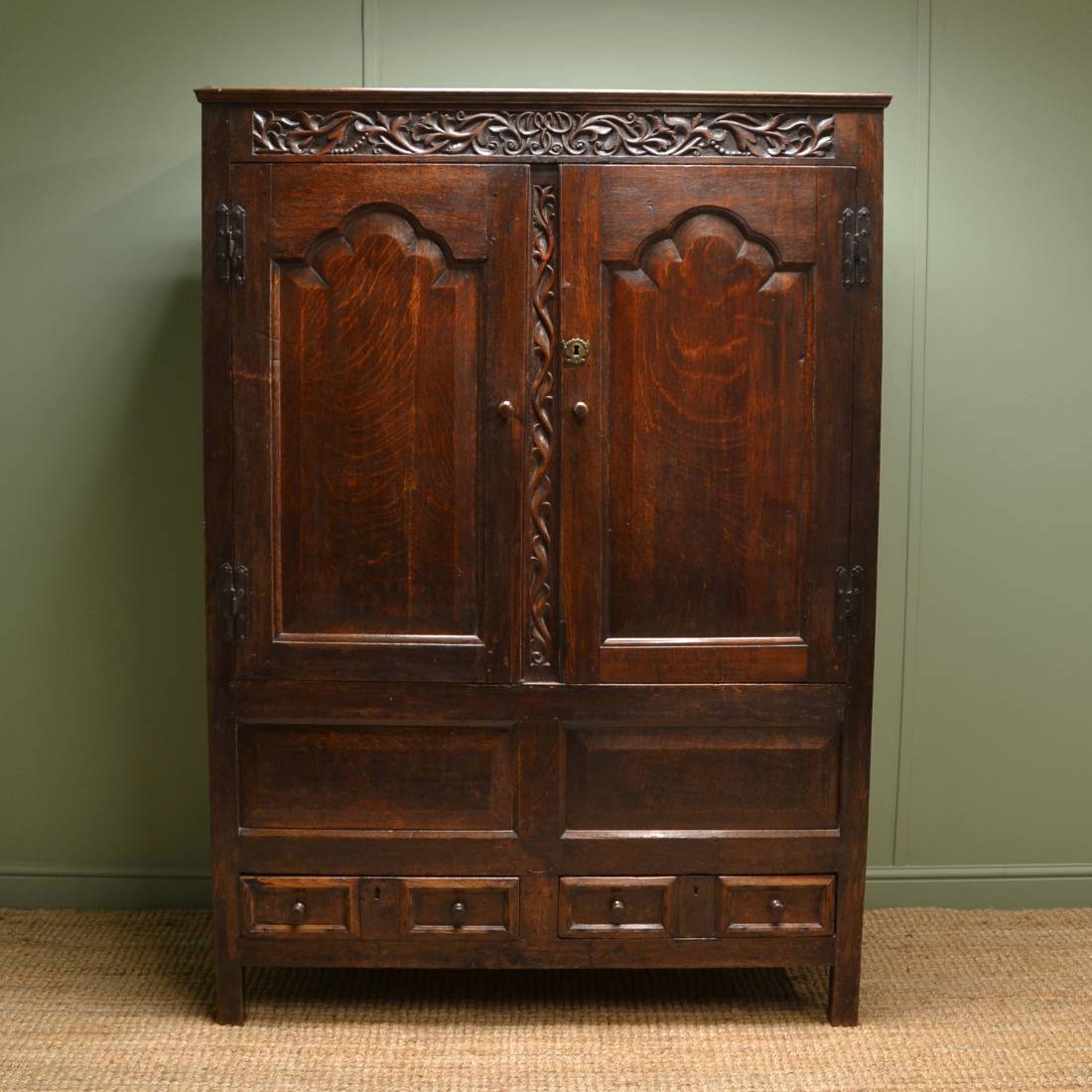 Early Eighteenth Century Antique Harness Cupboard with leaf and berry design carvings. 