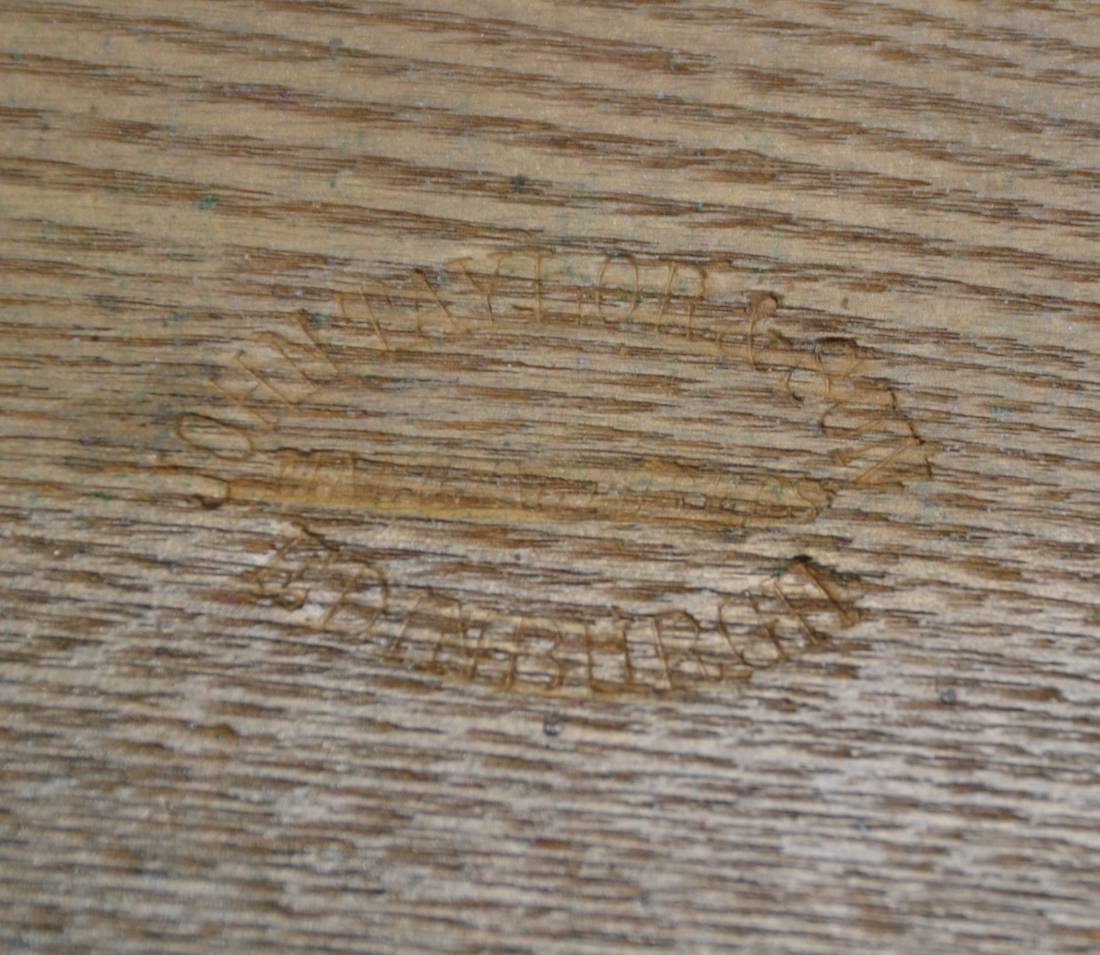 John Taylor Stamp embossed into the wood. 